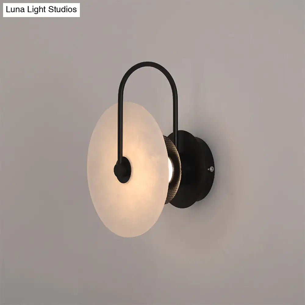 Modern white and black led wall sconce with frosted disc shade and woven texture accent for bedroom lighting