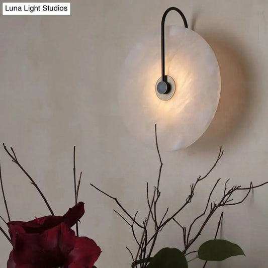 Modern white and black led wall sconce with frosted disc shade and sleek curved arm for fixture width optimization