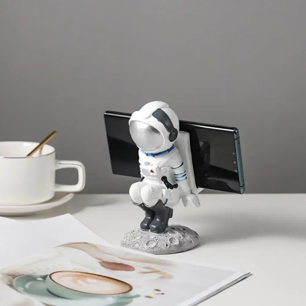 Modern white and blue decorbites astronaut resin figurines featuring a white resin astronaut holding a smartphone on a moon base