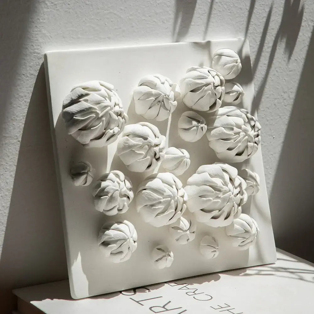 Modern white bud ceramic wall décor pendant featuring raised textured floral forms for bedroom sculptural art