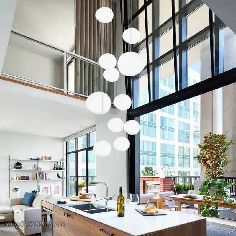 Modern white cascading glass pendant light features spherical glass pendant lights hanging in a cluster for dining room