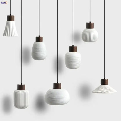 Modern white ceramic pendant light fixture with vertical ridges and dark wood accents for kitchen decor