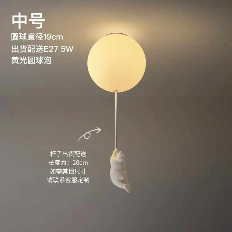 Modern white ceramic bear led ceiling light featuring a soft yellow spherical light with a white cat figurine for kids bedroom