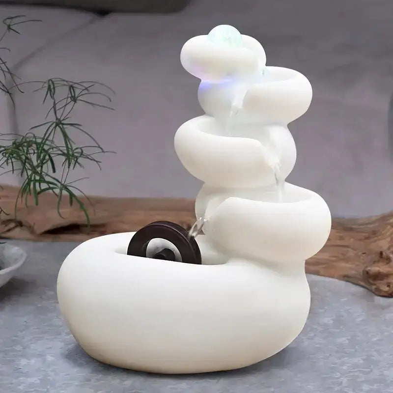 Modern white ceramic circulating water fountain with spiral design and glowing blue light for living room decorbites decor