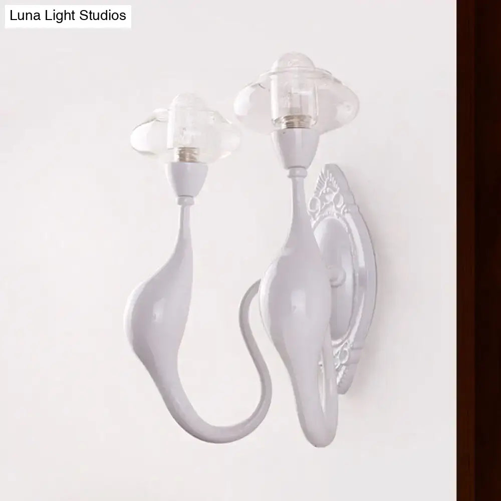 Modern white ceramic sconce light with cloud-shaped clear glass oval shades and curved sculptural arms for bedroom use