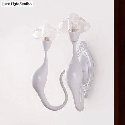 Modern white ceramic sconce light with cloud-shaped clear glass oval shades and curved sculptural arms for bedroom use