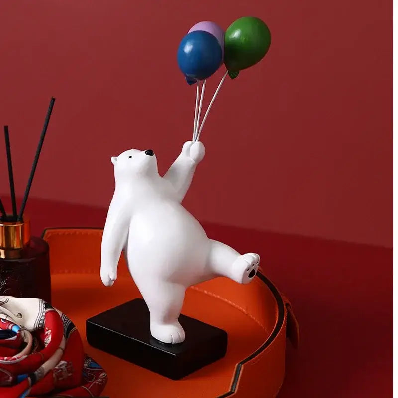 Modern white ceramic flying bear figurines featuring a white polar bear holding colorful balloons on black base for kids room decor