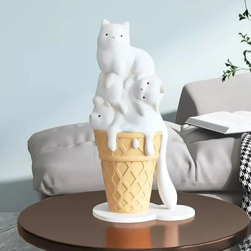 Modern white ceramic ice cream cat sculpture featuring three stacked cats inside a waffle cone with melting ice cream effect