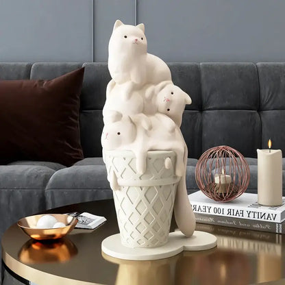 Cream-colored ceramic ice cream cat sculpture with three cats stacked on a waffle cone for modern living room decor