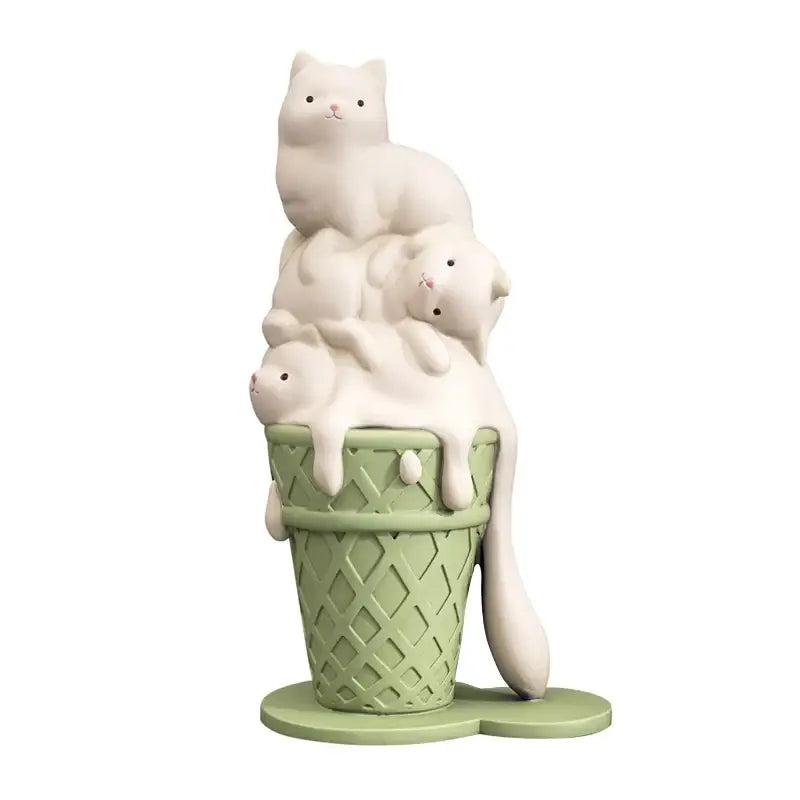 A modern white ceramic ice cream cat sculpture featuring three cats stacked in a light green waffle cone for decor