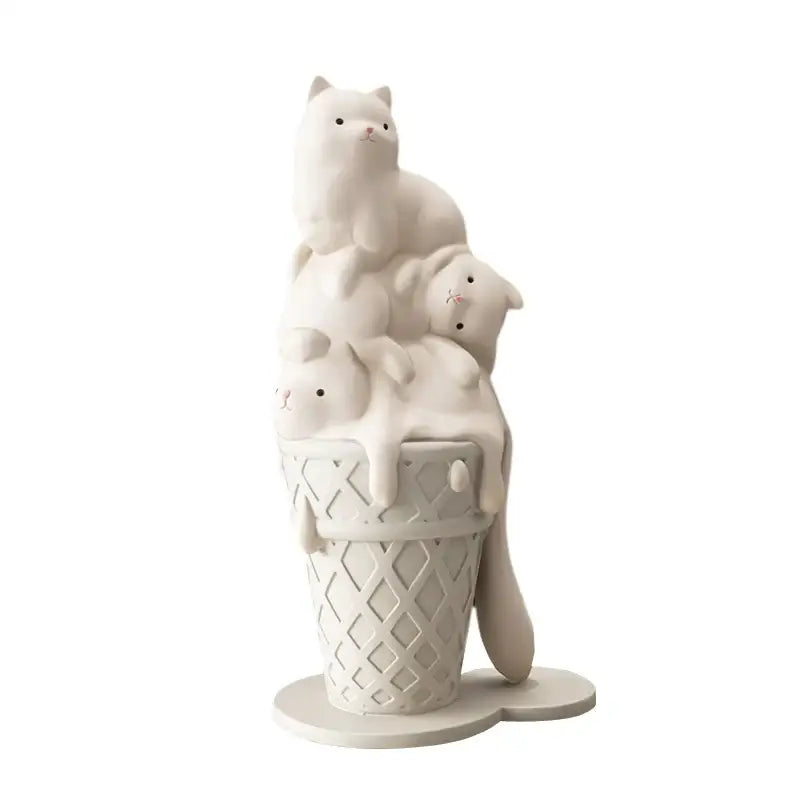 Modern white ceramic ice cream cat sculpture featuring three cats stacked inside a diamond-patterned waffle cone decor