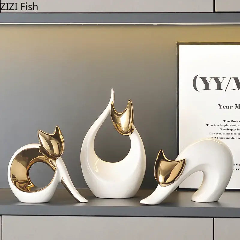 Three elegant white ceramic kitten statues with gold-accented ears for modern living room decor
