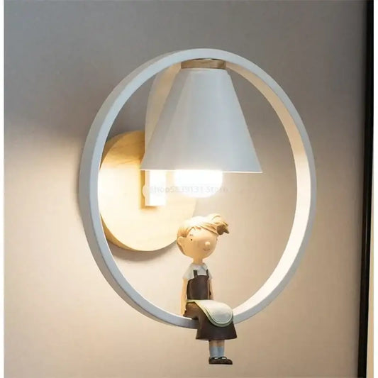 Modern white led wall lamp with a child figurine in overalls sitting on the circular frame for bedroom use
