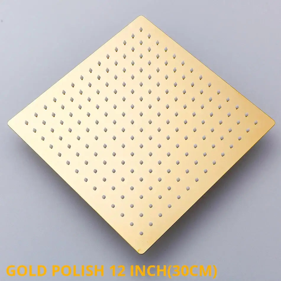Gold-polished 12-inch square rainfall shower head with evenly spaced perforations for modern bathroom use