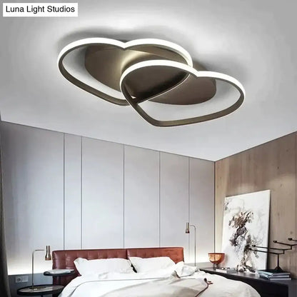 Modern white coffee pendant light featuring double-heart-shaped metallic frame with glowing led illumination for bedroom