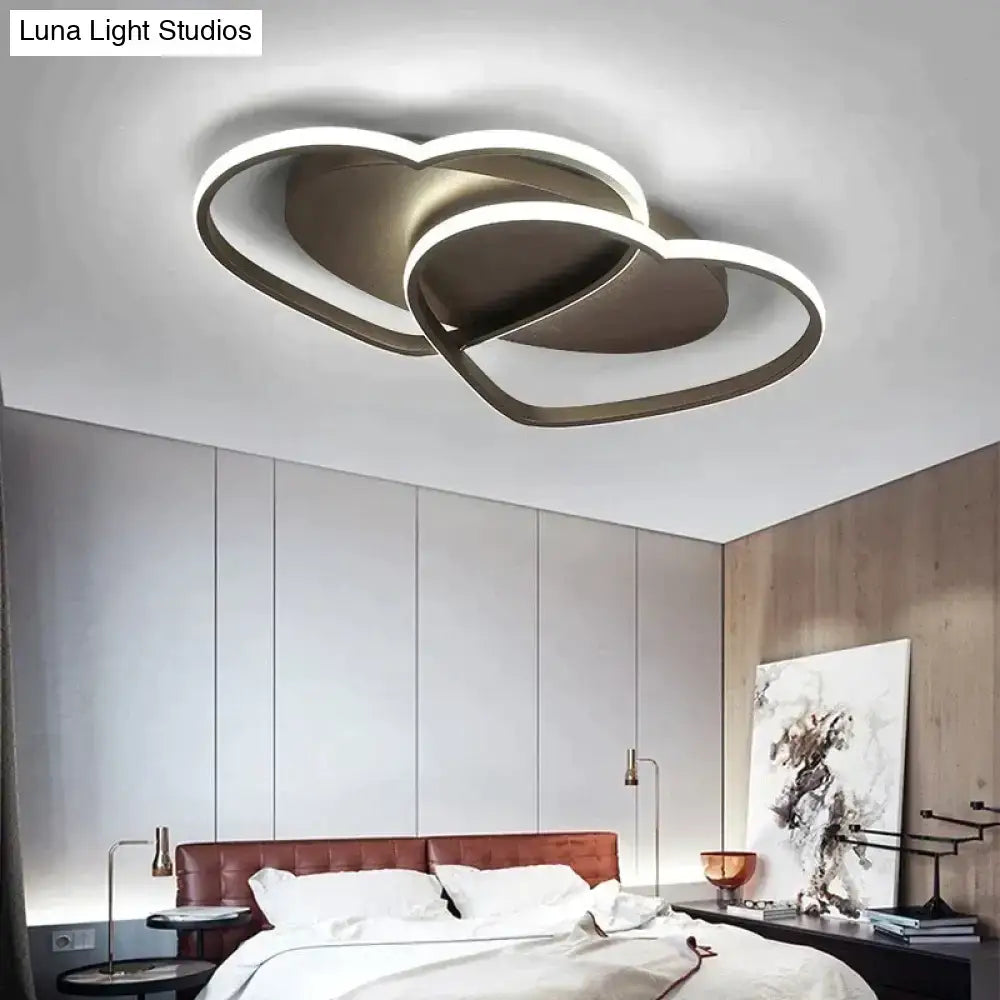 Modern white coffee pendant light featuring a double-heart-shaped metallic finish with glowing led rings for bedroom