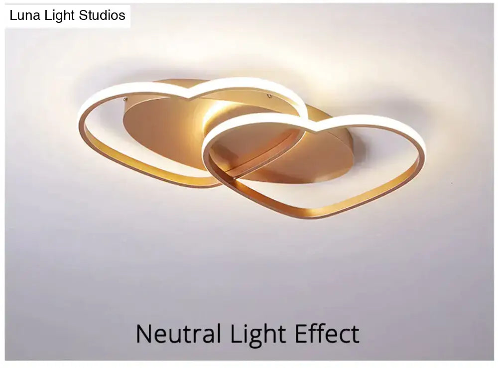 Modern white coffee pendant light with gold finish and interlocking heart-shaped led rings for bedroom lighting