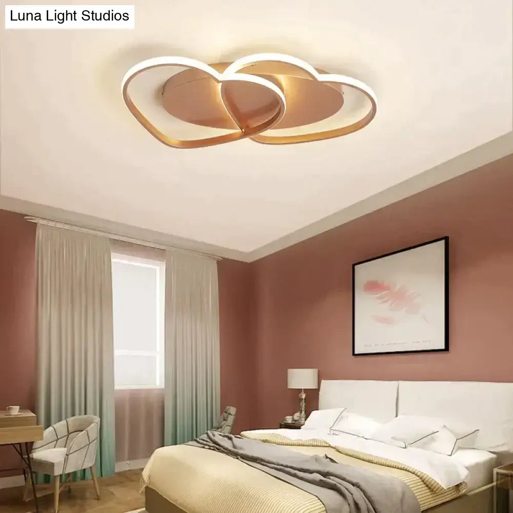 Gold-toned led pendant light with two interlocking heart-shaped rings for modern white coffee bedroom decor