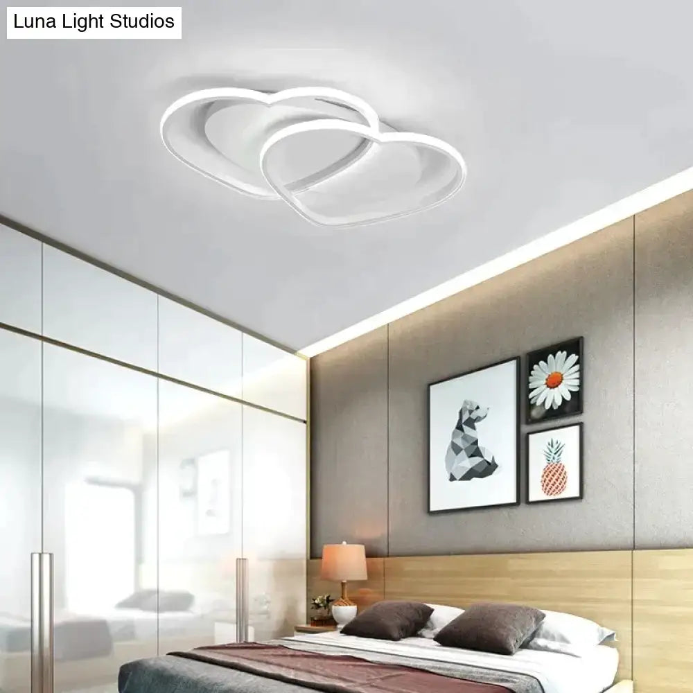 White modern pendant light with a sleek intertwined heart-shaped design for bedroom lighting in white coffee color