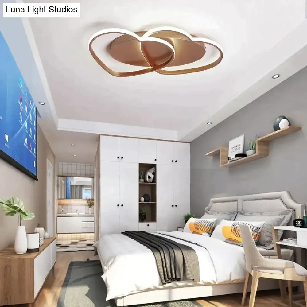 Modern white coffee pendant light with gold-toned cloud-shaped ceiling fixture and intertwined circular design for bedroom