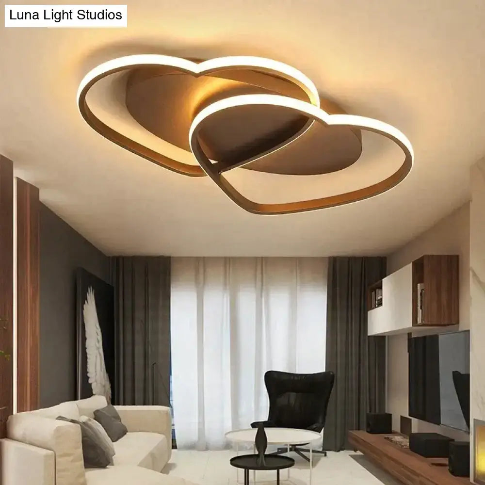 Modern white coffee pendant light with gold-toned led fixture shaped like two interlocking hearts for bedroom use