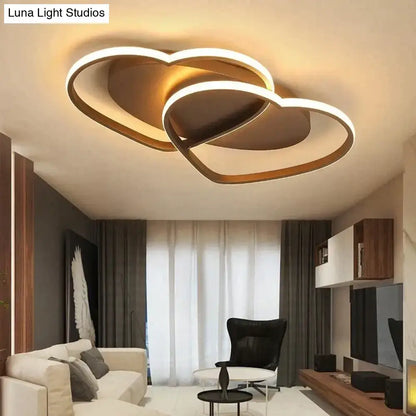 Modern white coffee pendant light with gold-toned led fixture shaped like two interlocking hearts for bedroom use