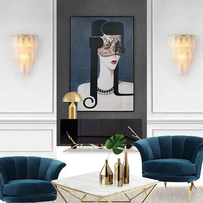 Portrait painting of a black and gold ornate mask with intricate lace detailing alongside modern white crystal feather wall lamp decorbites crystal feather sconce