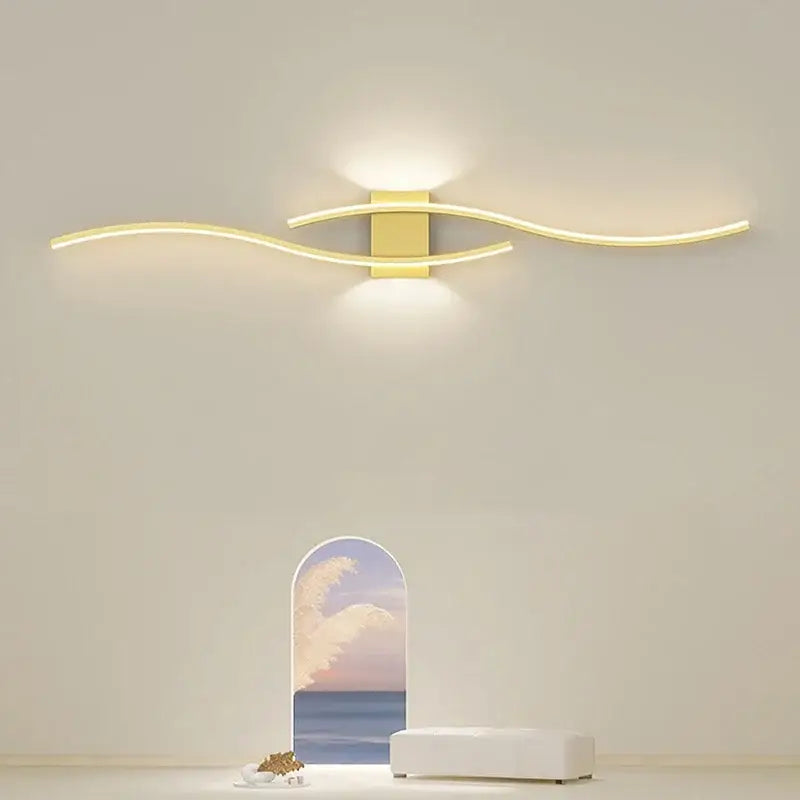 Modern gold-toned led wall light strip with sleek curved arms emitting warm glow for living room decorbites led wall