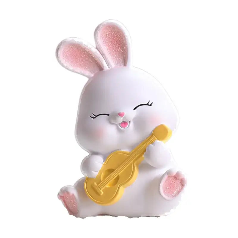 Modern white cute bunny figurine sculpture with pink glittery ears and paws holding a yellow ukulele for decor
