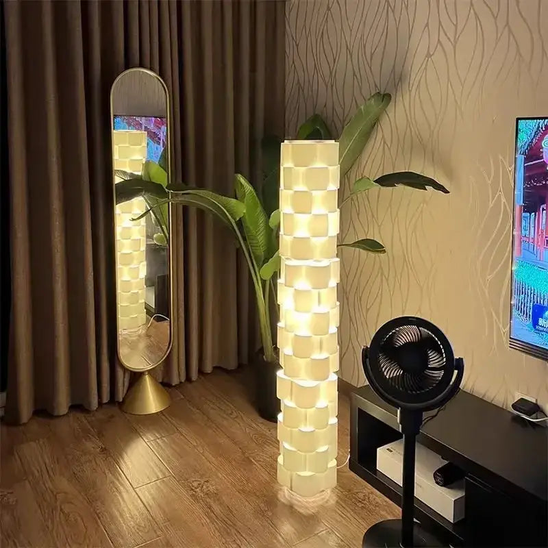 Modern white cylindrical vertical floor lamp with stacked cube design and warm white light for living room use