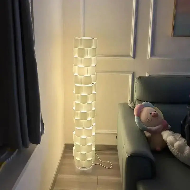 Modern white cylindrical vertical floor lamp with stacked illuminated cube segments for living room use