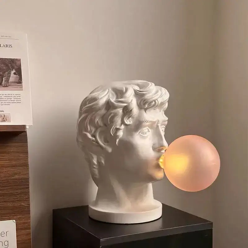 Modern white david sculpture table lamp with a marble-style bust and glowing peach bubble for decorbites david sculpture decor
