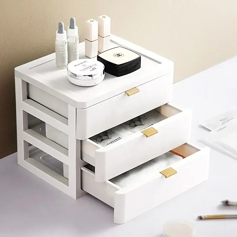 Modern white plastic decorbites desktop organizer drawer with three gold handles topped with cosmetic items