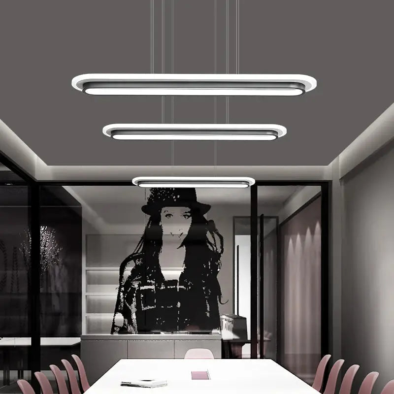 Three sleek modern white elliptical island led ceiling lights with minimalist acrylic design for table lighting