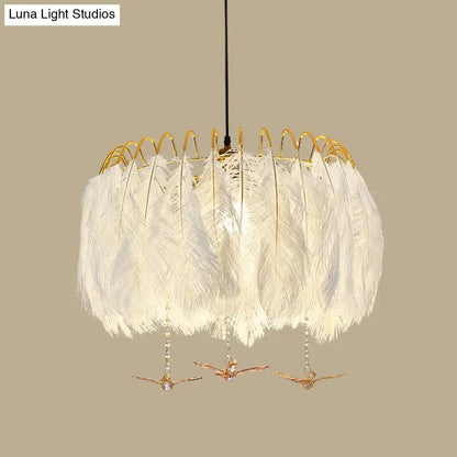 Modern white feather chandelier with gold wire frame and decorative bird charms for living room pendant lighting