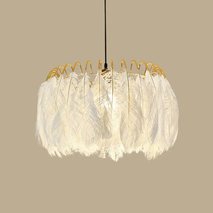 A modern white feather chandelier with a gold wire frame designed as a living room pendant light