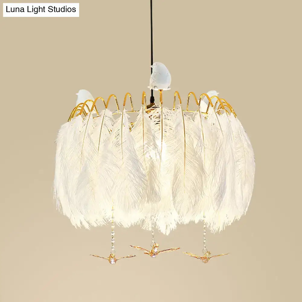 Modern white feather chandelier with gold wire accents and three small bird figurines for living room pendant light