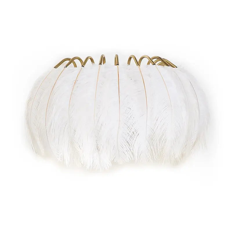 Modern white feather metal wall sconce with gold toned hooks for elegant bedroom lighting