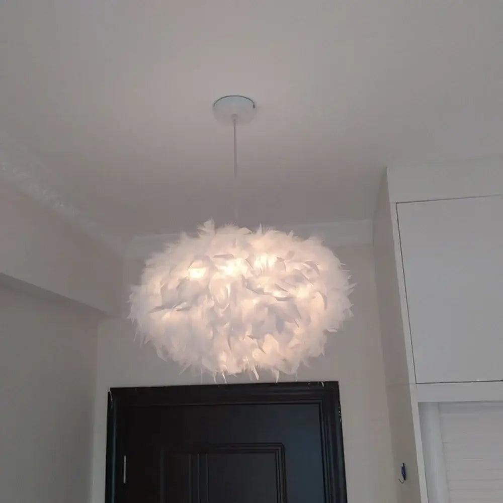 Modern white feather pendant light with soft cloud like design and chrome finish for bedroom use