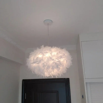 Modern white feather pendant light with soft cloud like design and chrome finish for bedroom use