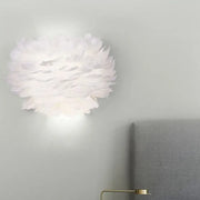 Modern white feather wall lamp with soft layered design for stylish home decoration and bedroom wall use