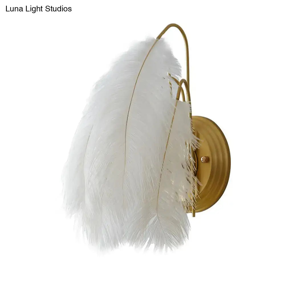 Modern white feather wall sconce with gold toned metal frame for bedroom single bulb lighting