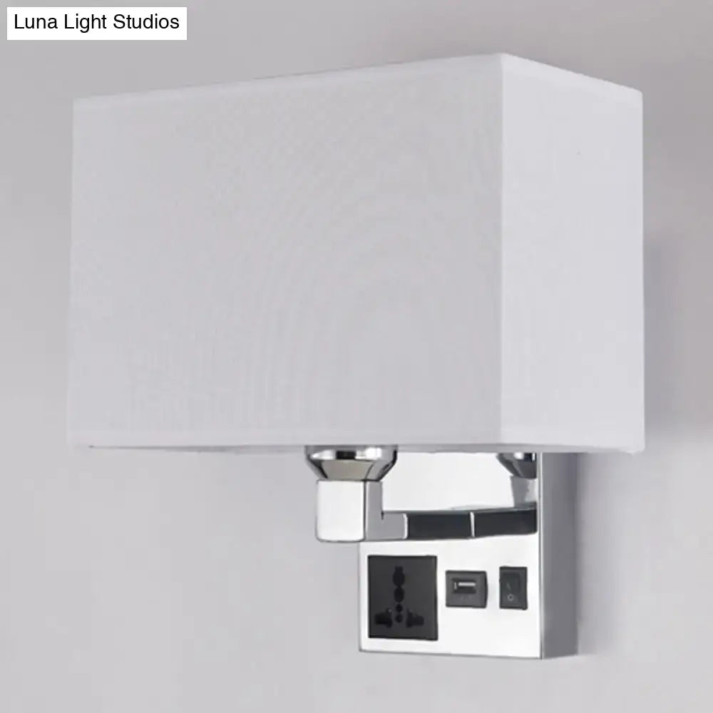 White rectangular fabric shade mounted on a chrome-finished wall sconce with integrated power outlets and usb port.