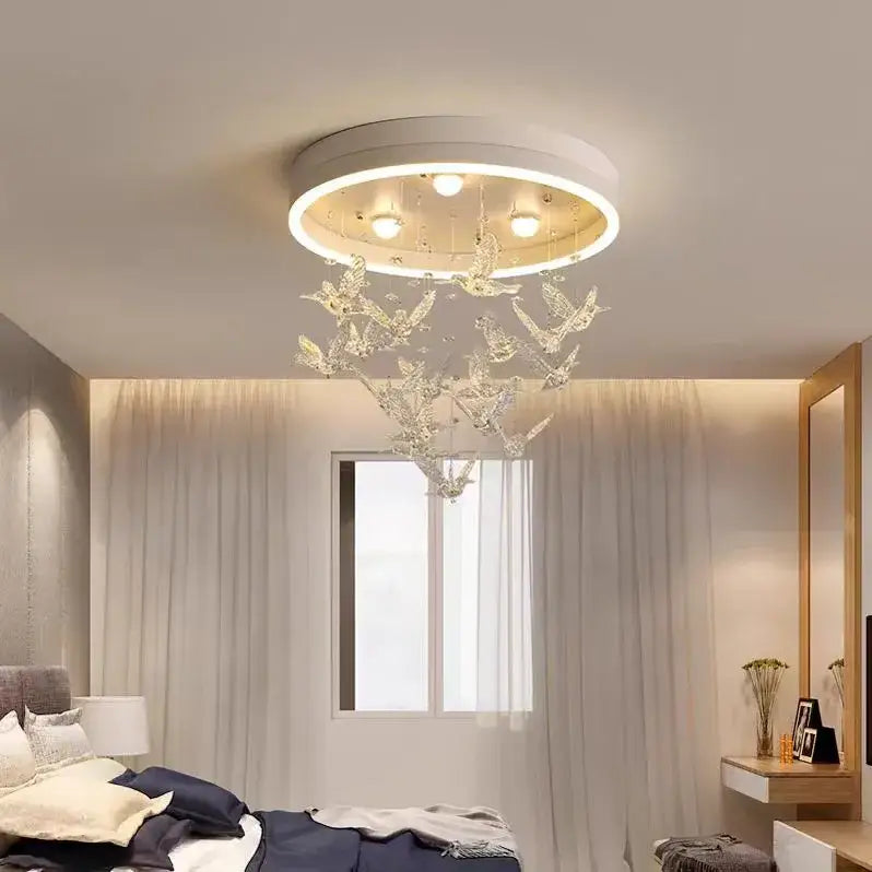 Modern white flying bird ceiling light for kids bedroom with a white base and hanging crystal bird ornaments decorbites flying bird