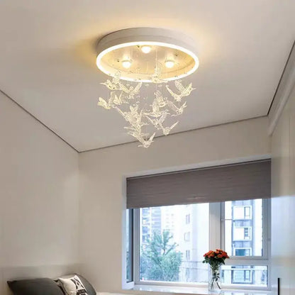Modern white flying bird ceiling light for kids bedroom with circular base, embedded bulbs, and transparent crystal decorbites flying bird ornaments