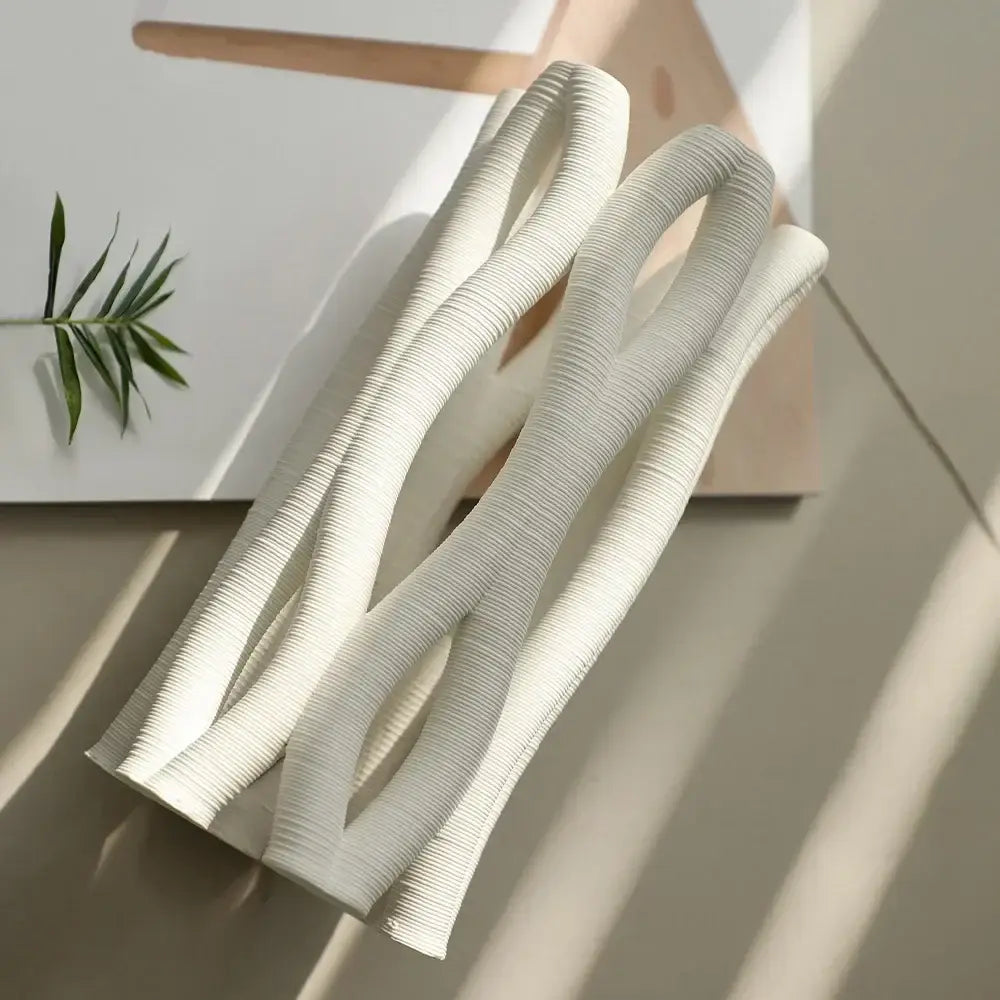 Modern white ribbed silicone heat-resistant utensil complementing decorbites geometric ceramic hollow vases design
