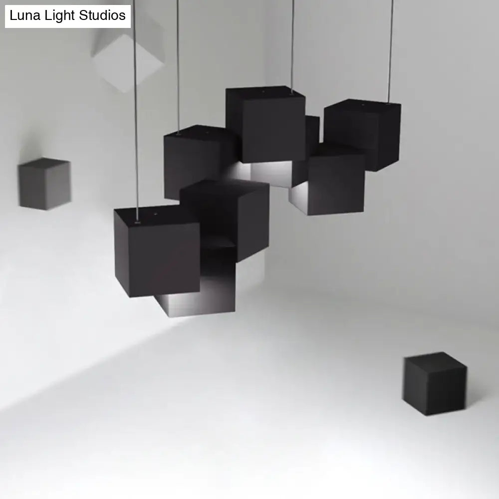 Modern white geometric led island light featuring black matte-finished geometric cube pendant lights suspended by cables