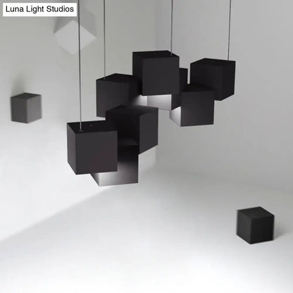 Modern white geometric led island light featuring black matte-finished geometric cube pendant lights suspended by cables