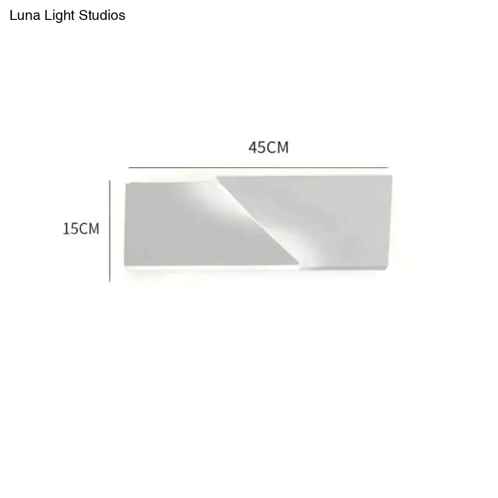 Modern minimalist rectangular wall sconce with a matte white finish and geometric design for living room illumination