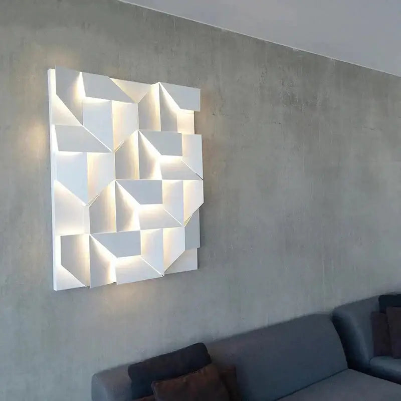 Modern white geometric wall lamp with illuminated facets ideal for living room art and ambient lighting